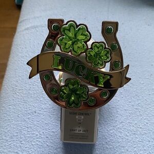 Bath & Body Works Gold plug with Green Gem Clovers and a hand sanitizer holder